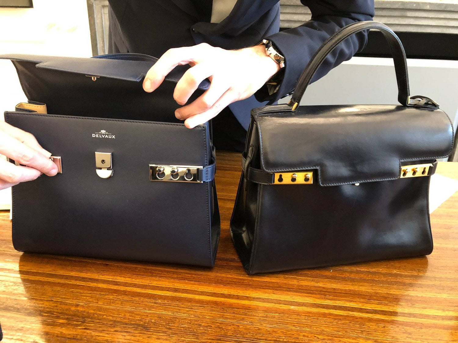 1970s vintage Delvaux Tempête handbag in marine blue box calf leather visiting the Delvaux flagship store "le 27" for a bag spa together with its new collection friend